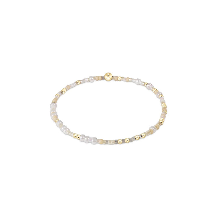 Enewton Hope Unwritten bracelet with silver-tone chain and engraved charm, laid flat on a neutral background.