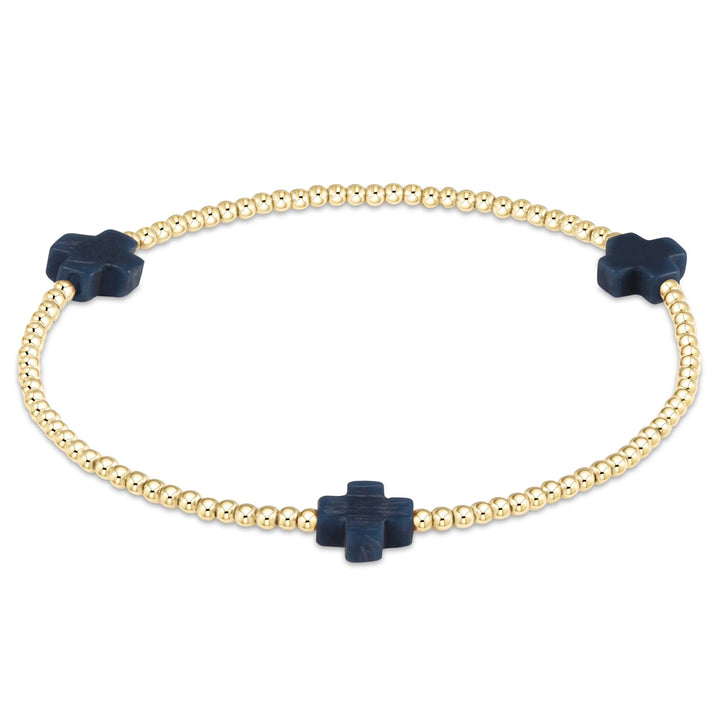 Gold Signature Cross 2mm bracelet from Enewton, showcasing a delicate cross charm on a sleek gold chain accessory.