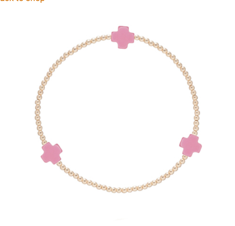 Gold Signature Cross 2mm bracelet by Enewton, featuring a delicate chain and small cross pendant, styled as a jewelry accessory.