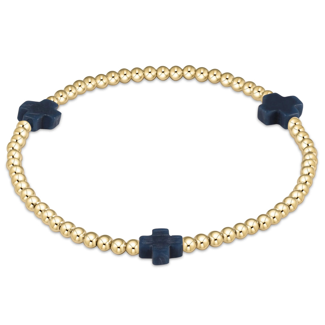 Enewton Signature Cross 3mm bracelet featuring a sleek metal cross charm on a black cord accessory.