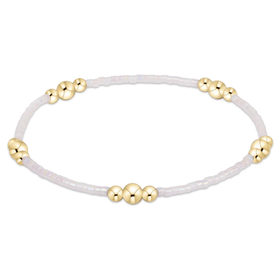 Enewton Hope Purpose Gold Bracelet with silky white band, showcasing elegant design and polished gold finish.