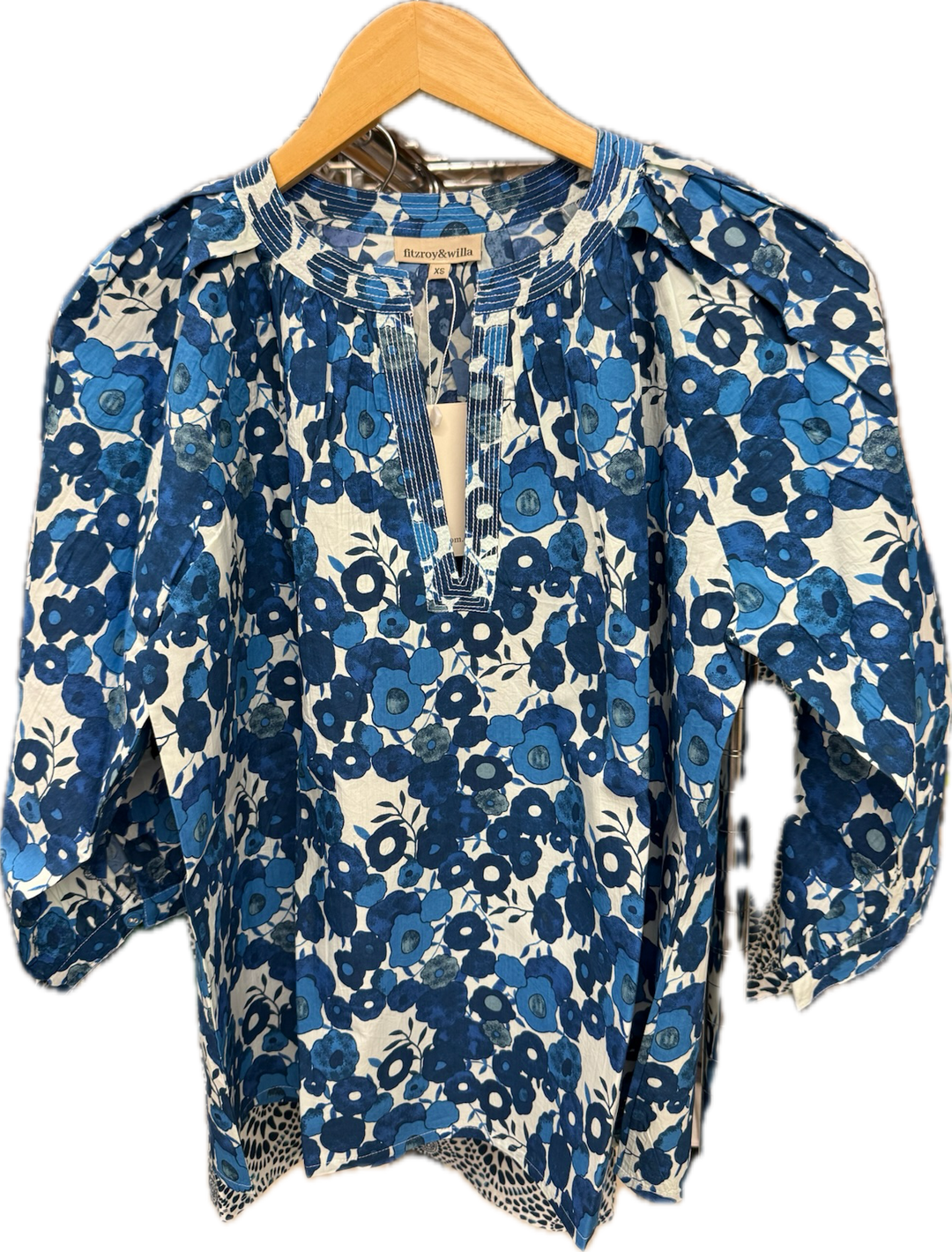 Fitzroy & Willa Sallie Blue Poppy blouse, a stylish women's top with a vibrant floral pattern and comfortable fit.