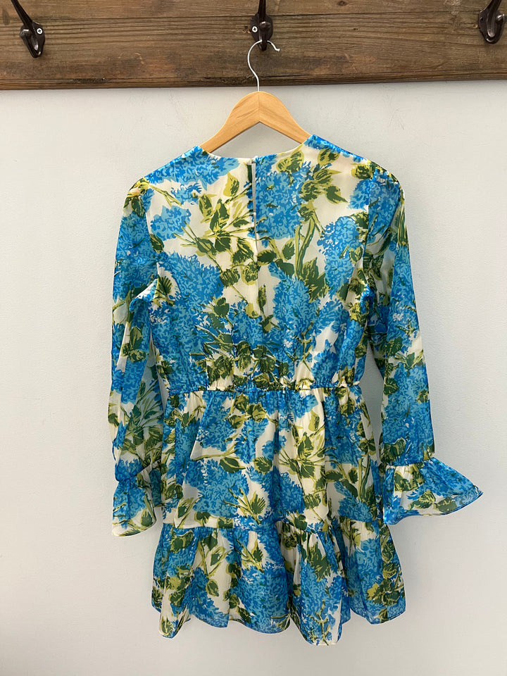 Flora Bea Monel Antigua dress displayed on a hanger, featuring a stylish, colorful patterned design perfect for casual or summer wear.