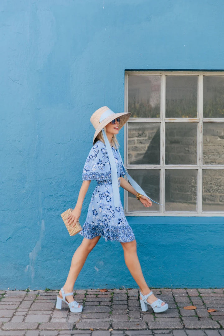 Woman walking in floral ruffle dress