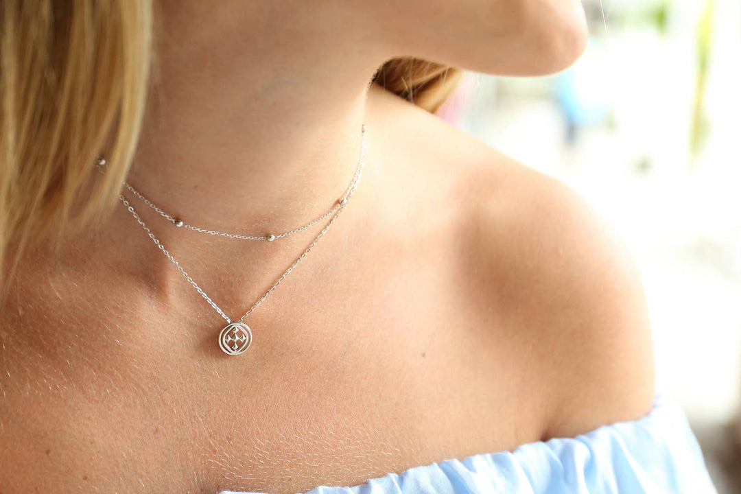 Gracewear Collection medallion pendant necklace with intricate design, hanging from a chain against a neutral background.