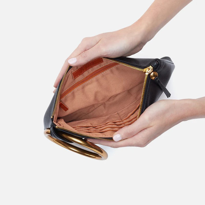 Black Sheila Ring Clutch by Hobo Bags showing a sleek, compact accessories clutch with a ring detail and smooth black finish.