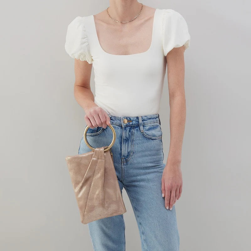 Hobo Bags Sheila Ring Clutch in Gilded Beige, elegant accessories with a circular ring detail, perfect for stylish evenings.