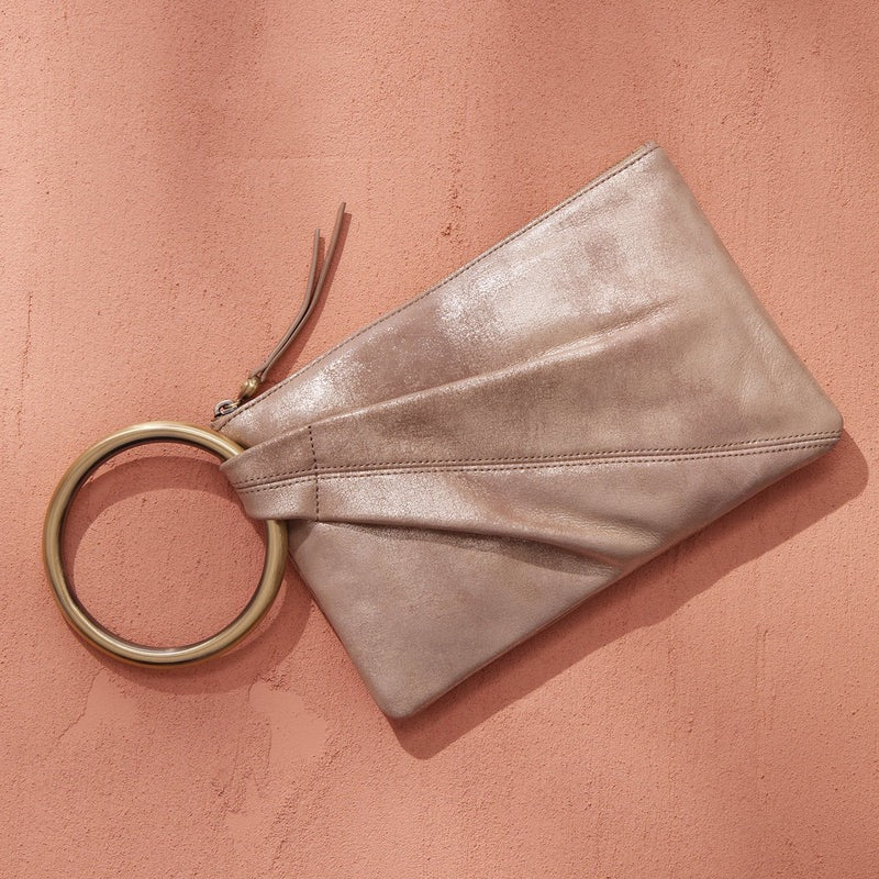 Hobo Bags Sheila Ring Clutch in Gilded Beige with metallic ring detail, stylish accessories for evening or special occasions.