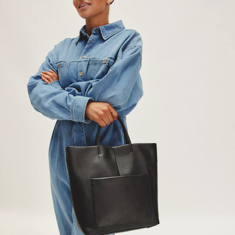 Hobo Bags Tripp Tote in black, a stylish accessories bag with sleek design and sturdy handles, perfect for everyday use.