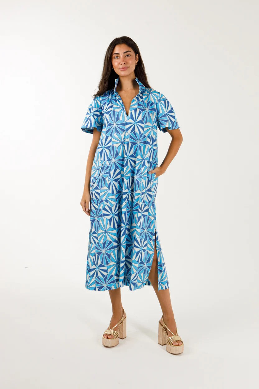 woman on white background wearing  blue kaleidoscope midi dress