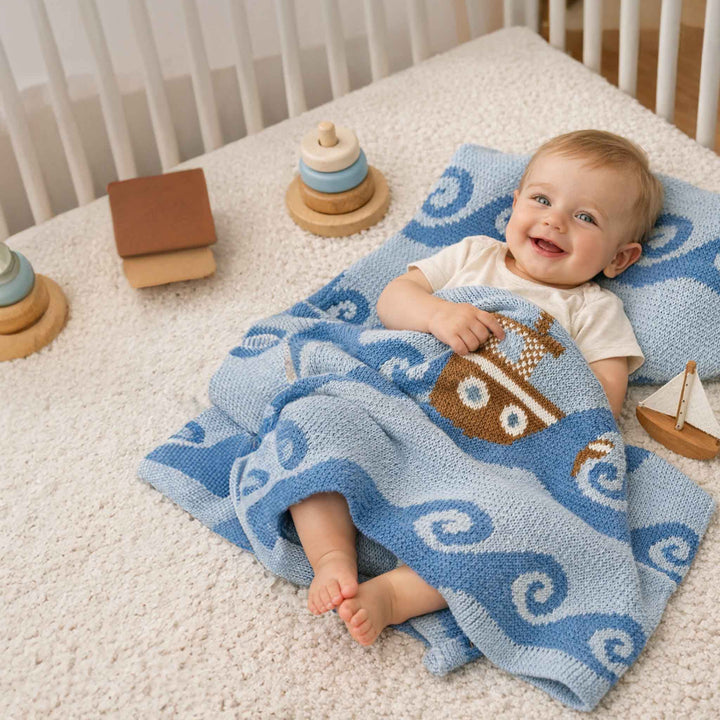 Soft Boats Cotton Baby Blanket by In2Green, featuring a cozy, breathable fabric with boat-themed patterns for infants.