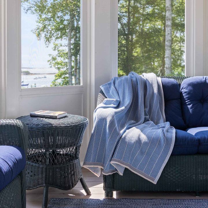 In2Green indoor/outdoor chevron throw blanket with black and white geometric pattern on soft fabric, suitable for home or outdoor use.