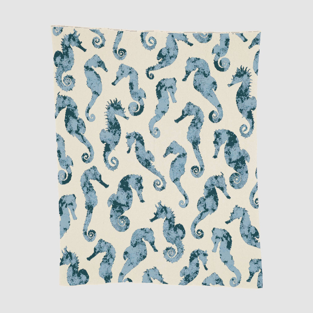 Watercolor seahorse design on In2Green cotton throw blanket, showcasing vibrant ocean-inspired artwork and soft fabric texture.