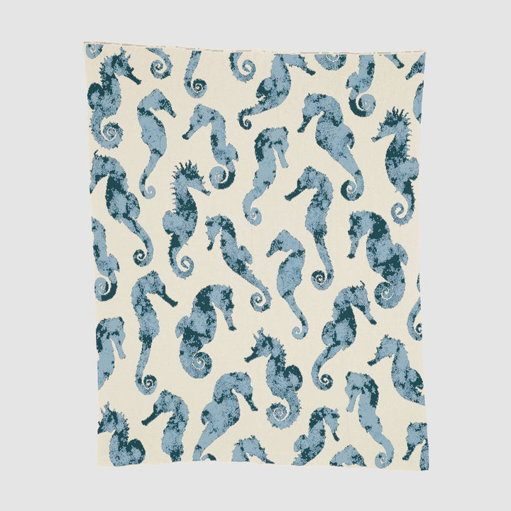 Watercolor seahorse design on In2Green cotton throw blanket, showcasing vibrant ocean-inspired artwork and soft fabric texture.
