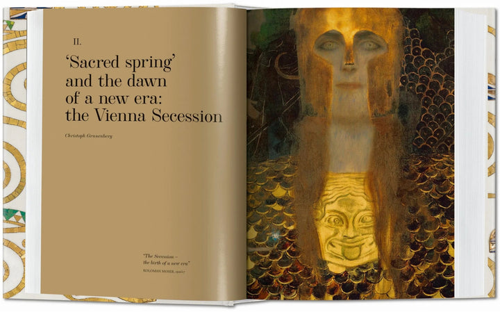 Open book showing pages of Gustav Klimt's complete paintings, featuring detailed images of his iconic artwork.