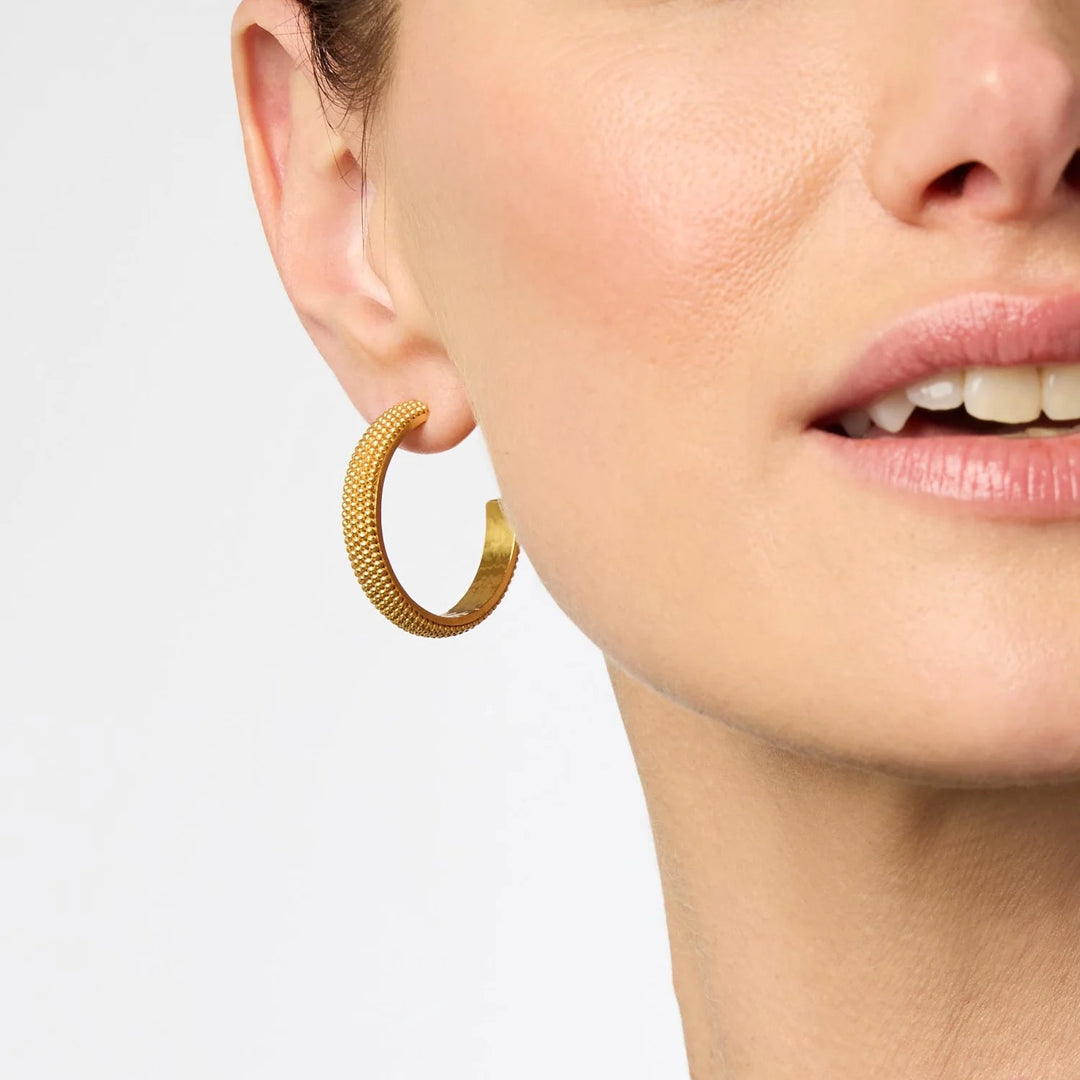 Beaded eternity hoop earrings by Julie Vos featuring intricate beaded designs and gold-tone metal hoops.