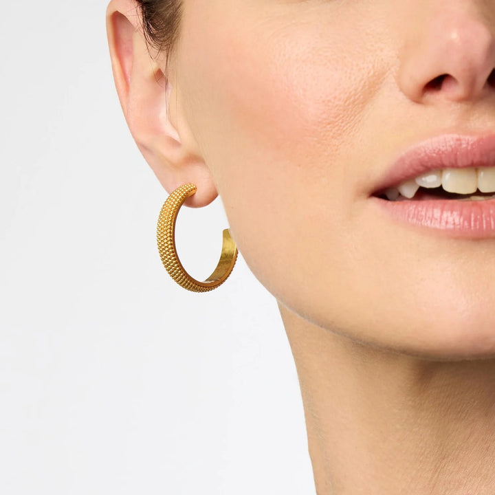 Beaded eternity hoop earrings by Julie Vos featuring intricate beaded designs and gold-tone metal hoops.