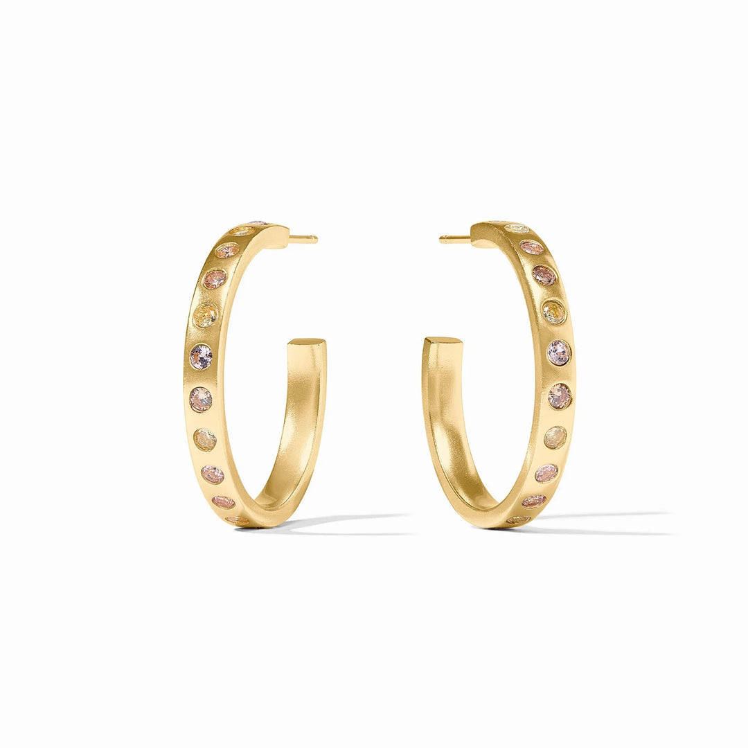 Colorful rainbow hoop earrings by Julie Vos, showcasing vibrant, polished metal hoops as stylish accessories.