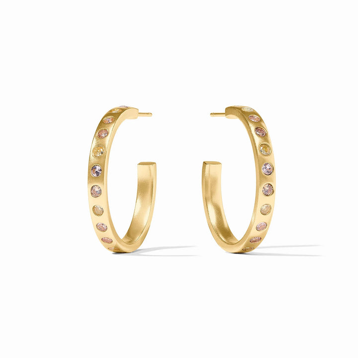 Colorful rainbow hoop earrings by Julie Vos, showcasing vibrant, polished metal hoops as stylish accessories.
