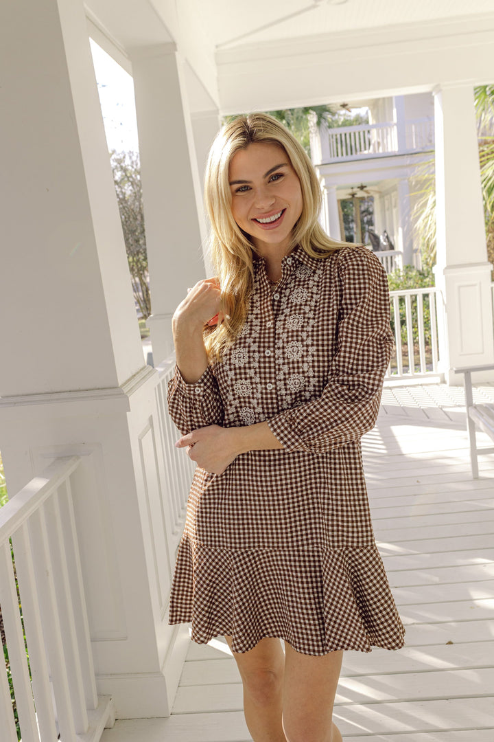 Gingham ruffle shirt dress by Sail to Sable, featuring a classic pattern, ruffle details, and a button-front design.