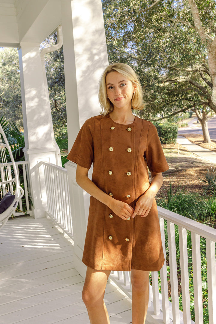 Camel suede button dress by Sail to Sable featuring a sleek silhouette and button details, displayed on a hanger.