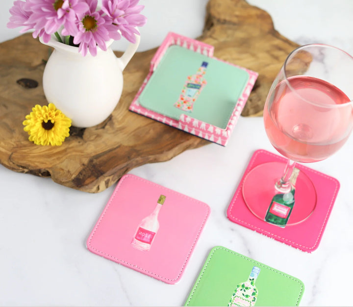 Set of four colorful Keva Style home coasters with vibrant, decorative designs on a wooden surface.