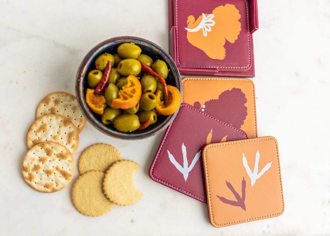 Set of 4 colorful Keva Style home coasters with vibrant patterns, perfect for protecting surfaces.