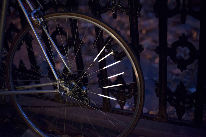 Set of 12 bike spoke reflectors by Kikkerland Design Inc, small reflective accessories for bicycle wheels.