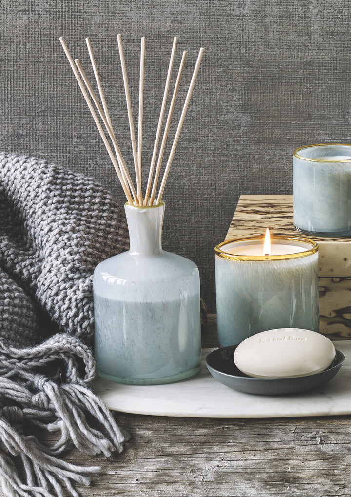 Lafco 15.5oz home candle in a sleek glass container, showcasing a warm, inviting flame and elegant design.