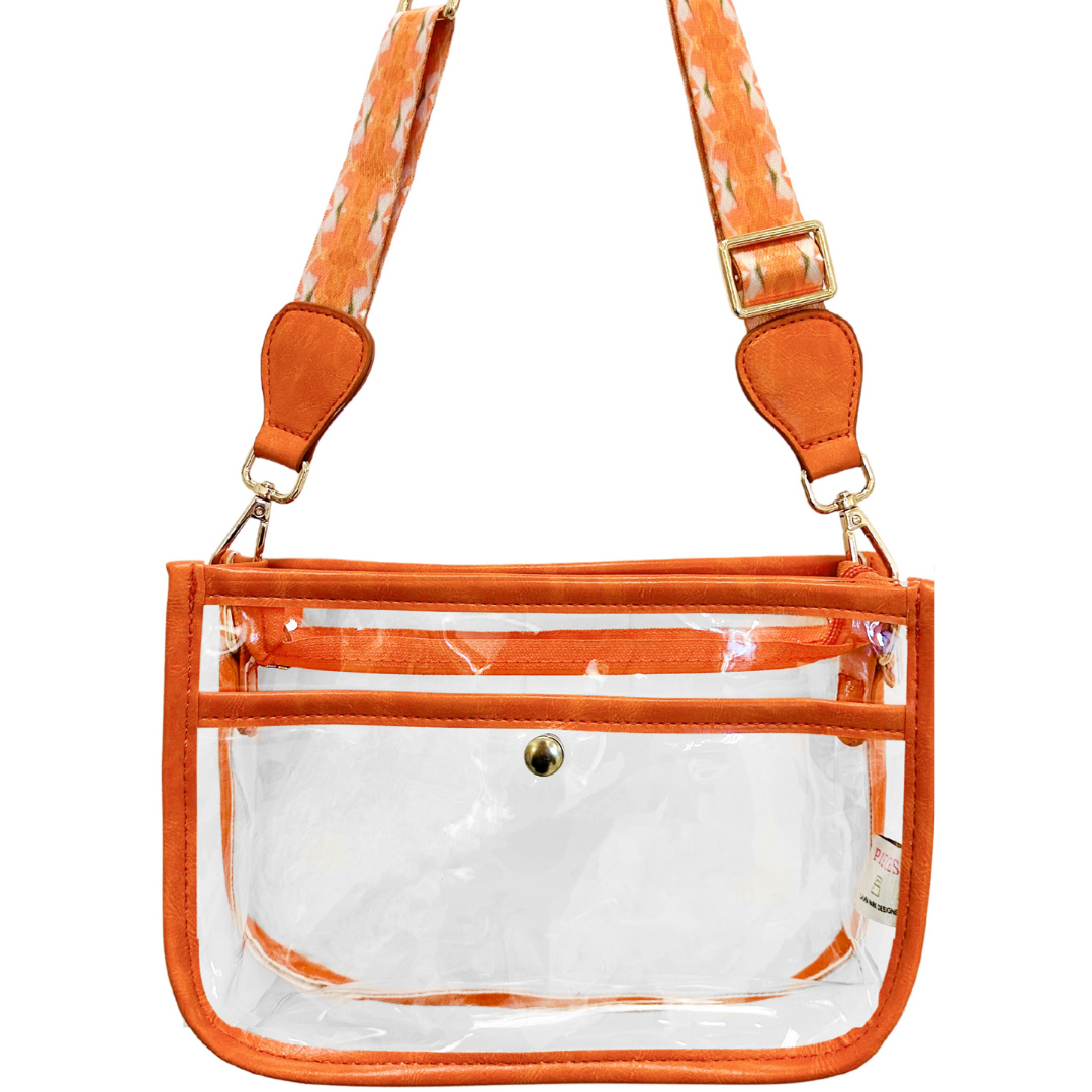 Clear stadium bag by Laura Park Designs, accessory with transparent material and sturdy handles for secure event entry.