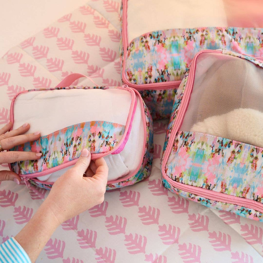 Laura Park Designs Brooks Avenue Packing Cubes gift set with multiple organized, colorful fabric cubes for travel storage.