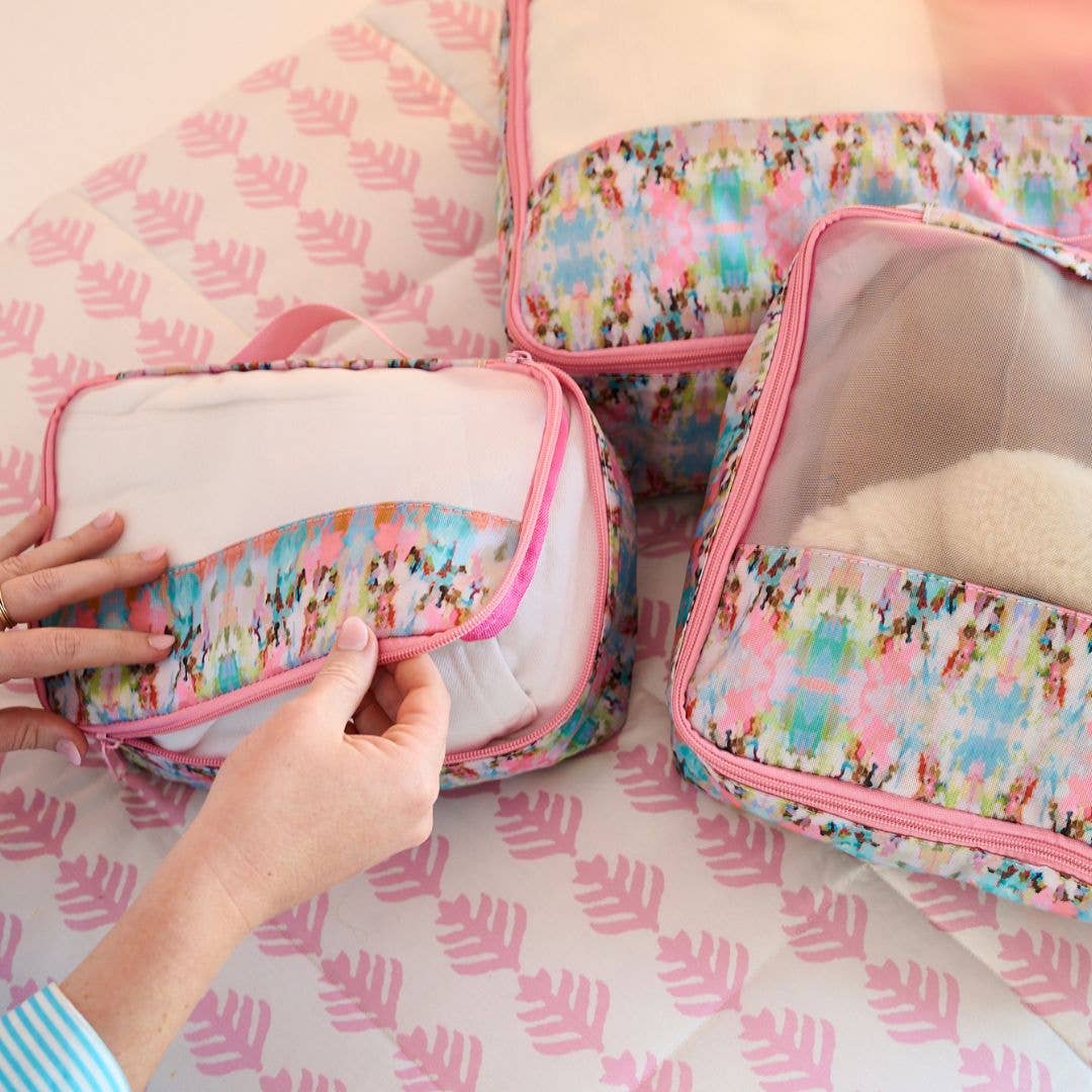 Laura Park Designs Brooks Avenue Packing Cubes gift set with multiple organized, colorful fabric cubes for travel storage.