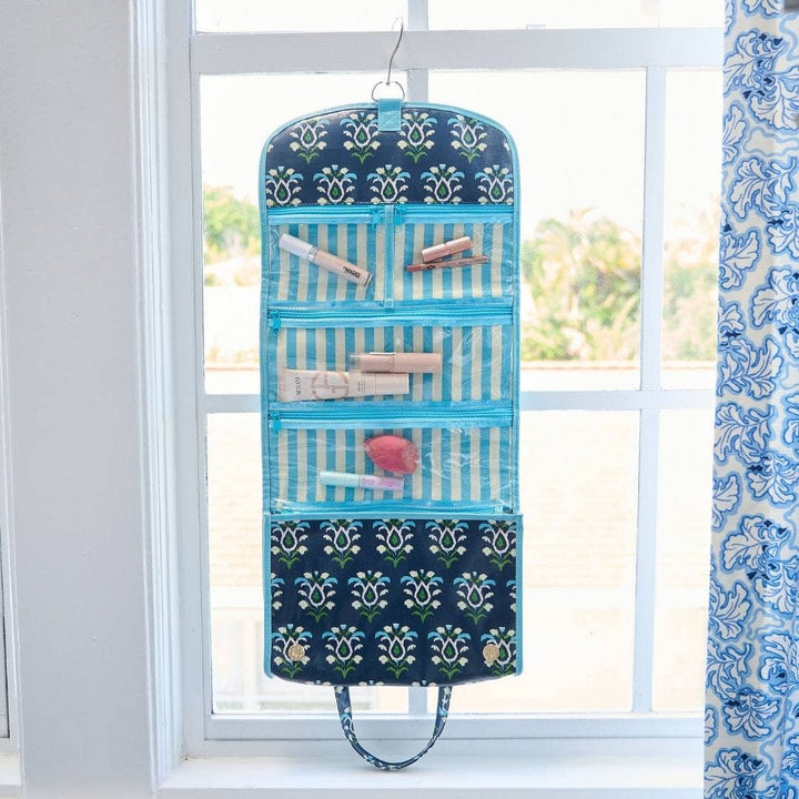 Rosemary Indigo hanging travel case by Laura Park Designs, a compact gift bag with a colorful floral design and sturdy handles.