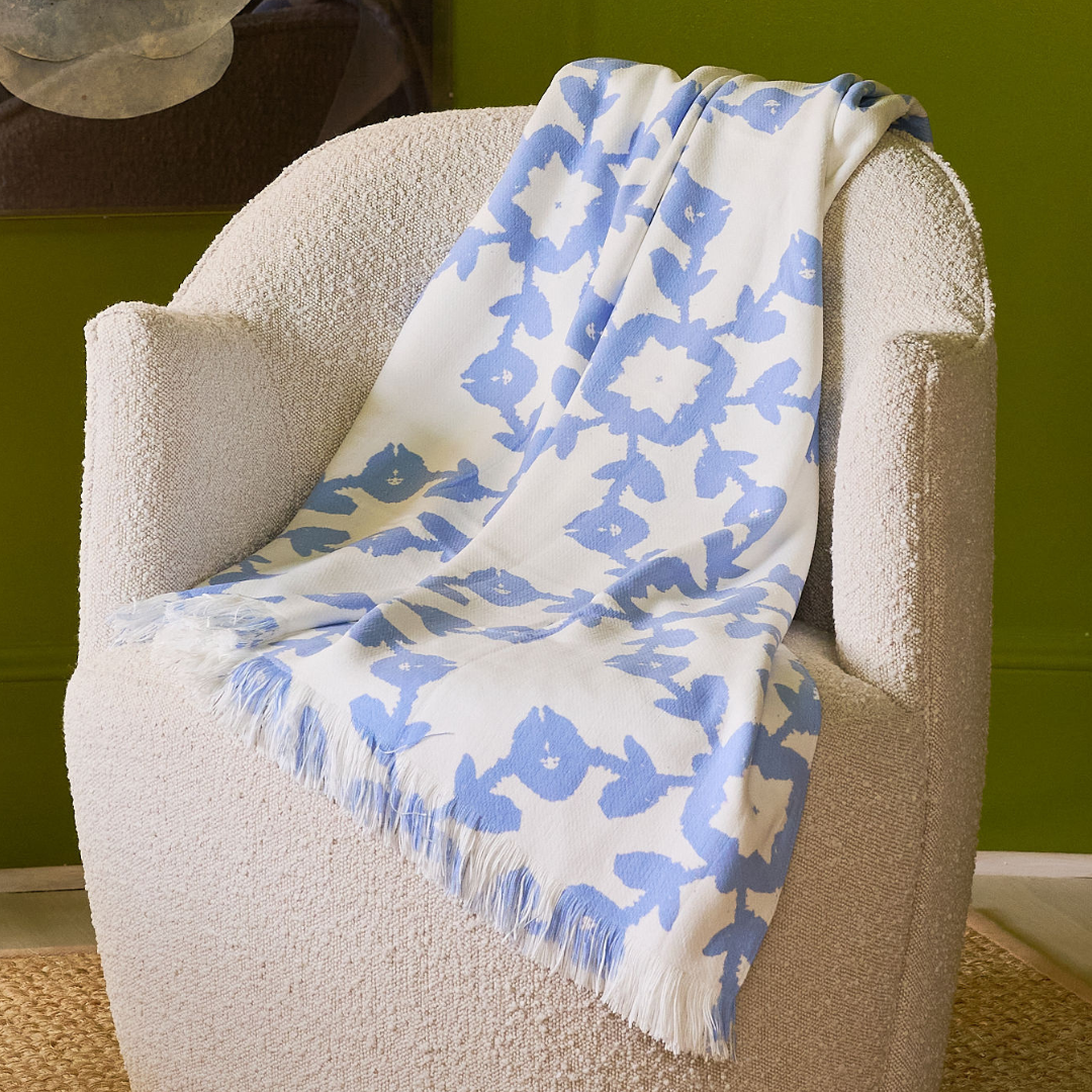 Laura Park Designs Highlands Chambray Throw Blanket displayed on a cozy sofa in a home setting.