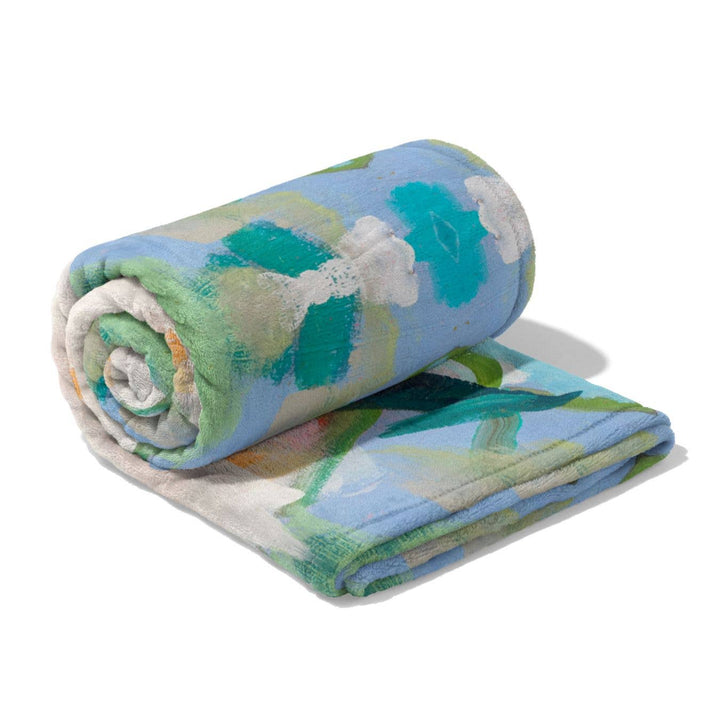 Laura Park Designs Island House fleece blanket, soft and cozy home textile with island-inspired pattern, perfect for relaxing.