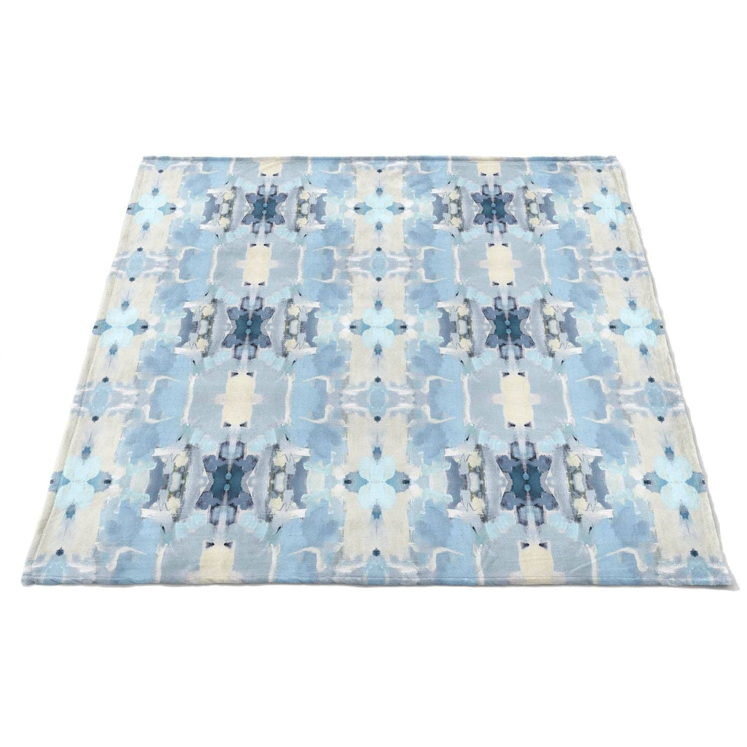 Laura Park Designs Ocean Breeze fleece blanket featuring soft, cozy fabric with ocean-inspired blue and white patterns for home decor.