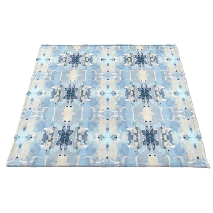 Laura Park Designs Ocean Breeze fleece blanket featuring soft, cozy fabric with ocean-inspired blue and white patterns for home decor.