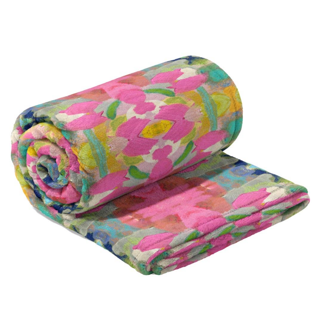 Soft pink fleece blanket from Laura Park Designs, cozy home decor with plush fabric and a smooth, inviting texture.