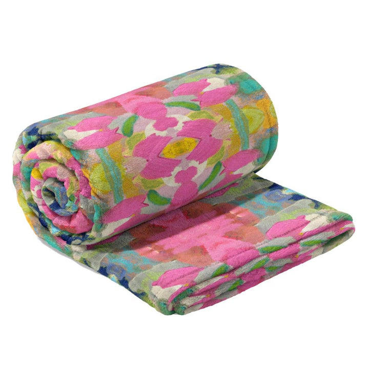 Soft pink fleece blanket from Laura Park Designs, cozy home decor with plush fabric and a smooth, inviting texture.