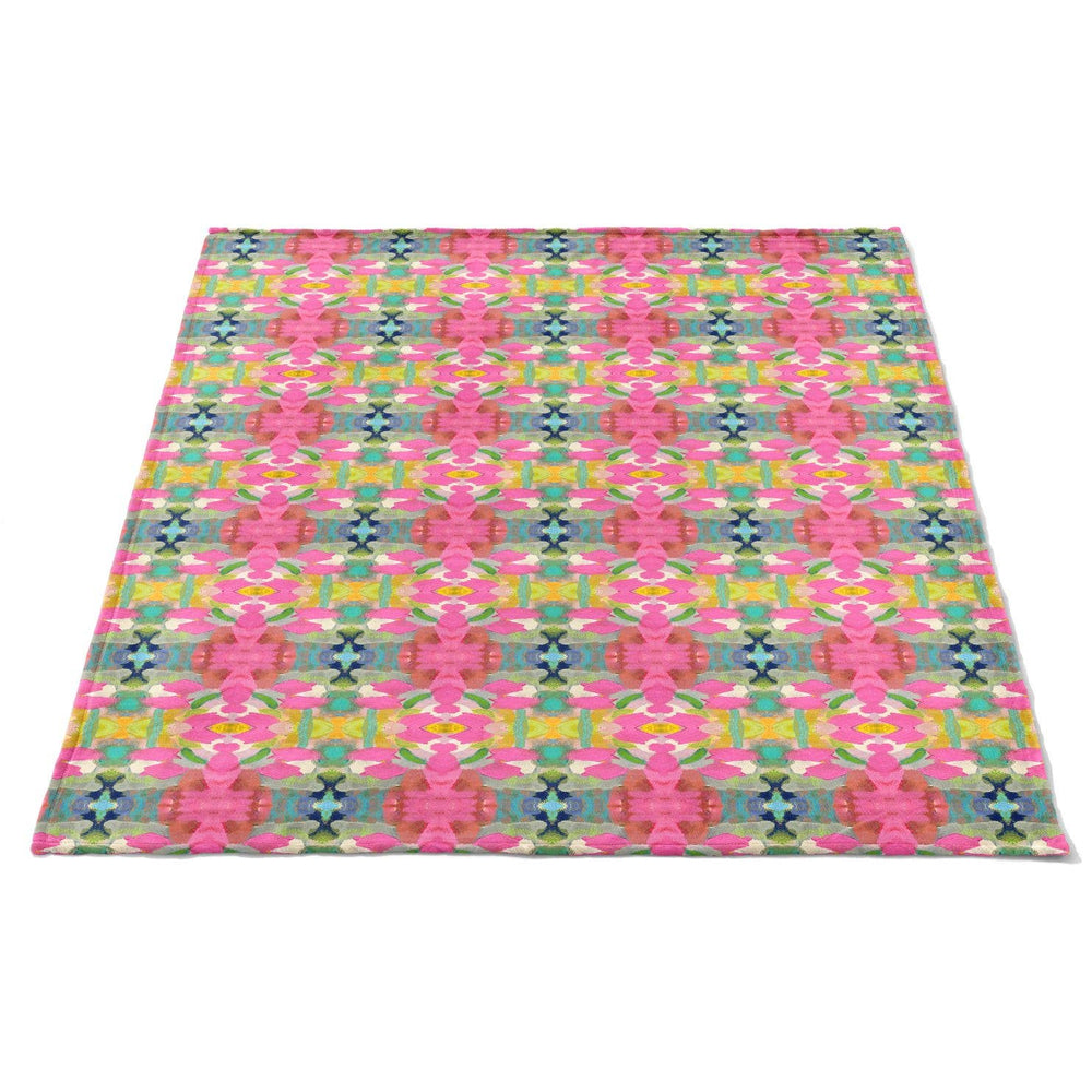 Soft pink fleece blanket from Laura Park Designs, cozy home accessory with plush texture and vibrant color.