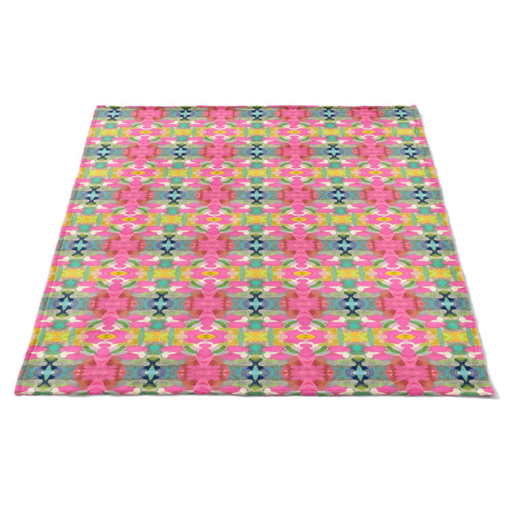 Soft pink fleece blanket from Laura Park Designs, cozy home accessory with plush texture and vibrant color.