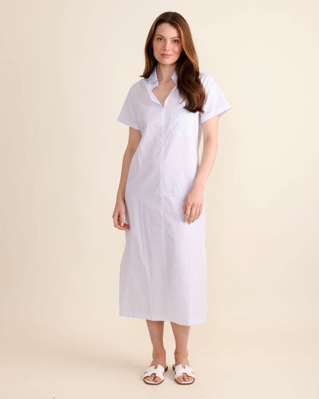 Le Marais Kiawah Blue Stripe Dress displayed on a hanger with a relaxed fit and vibrant blue and white stripe pattern.