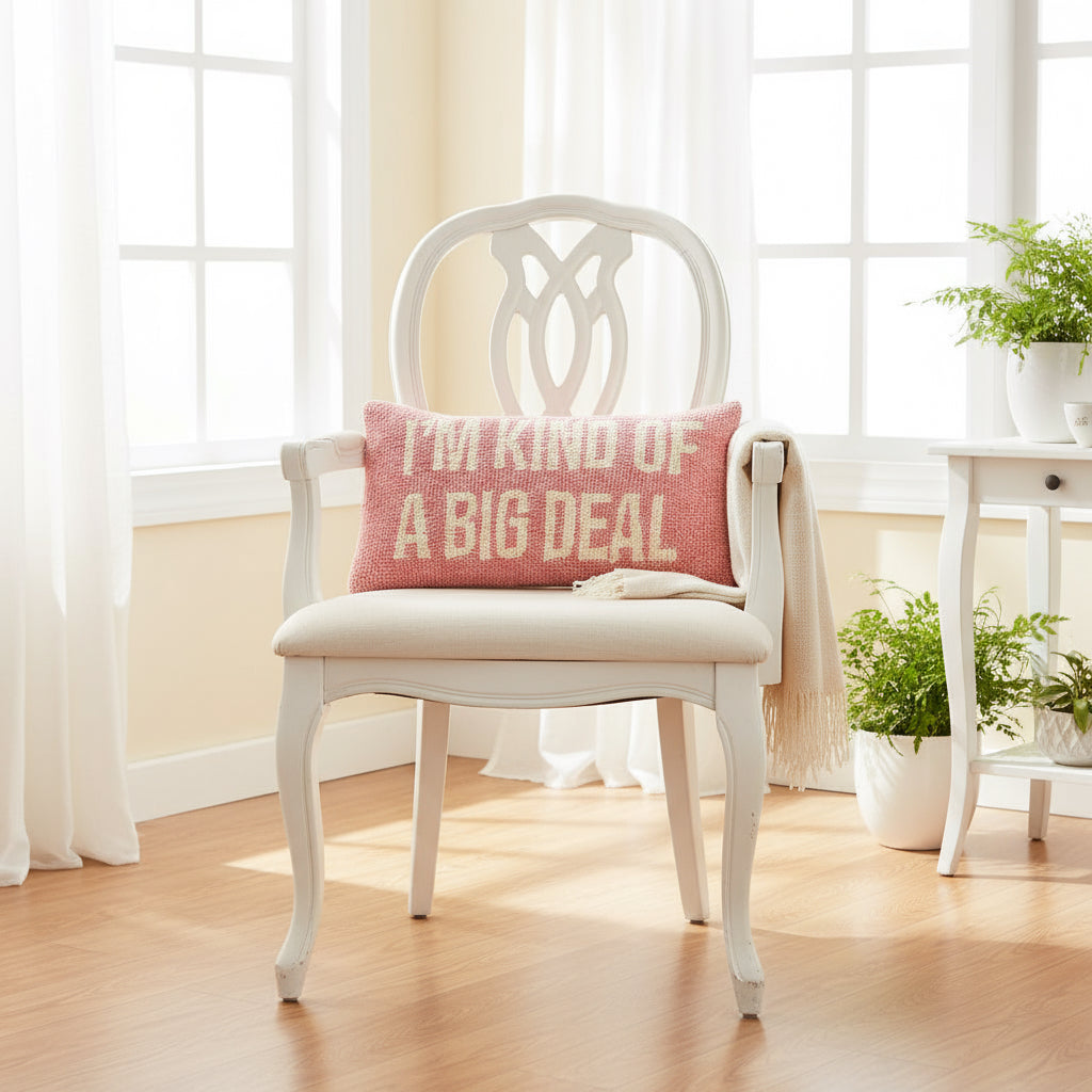 Pink pillow with 'I'm kind of a big deal' text on a gray couch