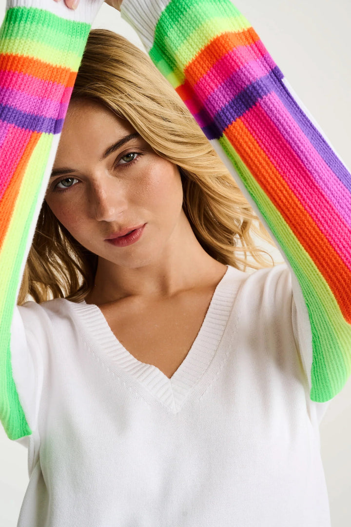 Lisa Todd International Brite Side Cotton Sweater, a soft white tops with a relaxed fit and ribbed cuffs, displayed on a hanger.