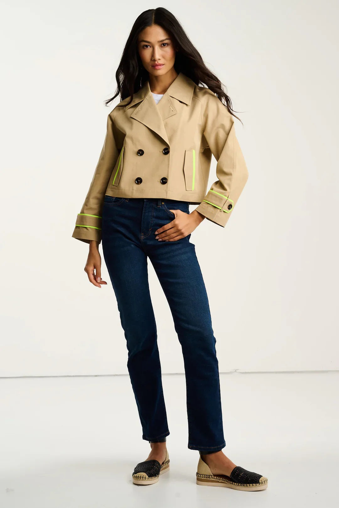 Lisa Todd International trench coat tops, stylish and tailored, shown in a detailed close-up with fabric texture and button details.