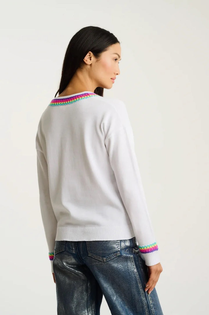 Lisa Todd International In The Mix sweater, a stylish knitted top with colorful patterns and a cozy fit, shown on a model.