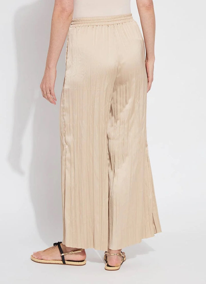 Lysse packable 28-inch palazzo pants in lightweight, flowy fabric, shown folded and laid flat as stylish, comfortable bottoms.