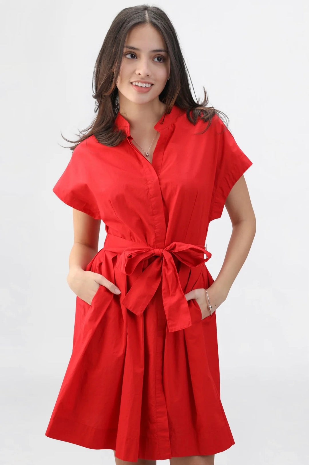 Red Winnie dress by Navy Bleu featuring a stylish design, displayed on a hanger with a focus on the vibrant fabric and details.