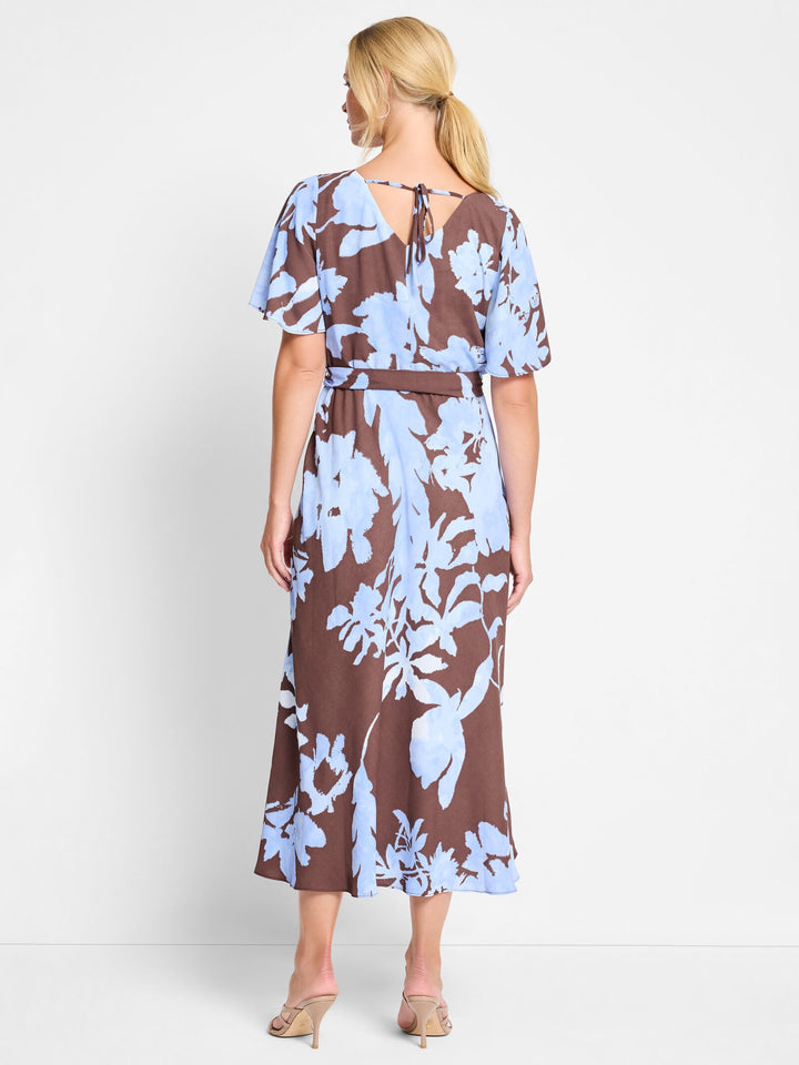 Nic & Zoe Cloud Blossom Brooke Dress hanging on a display, showcasing its flowy fabric and floral pattern.