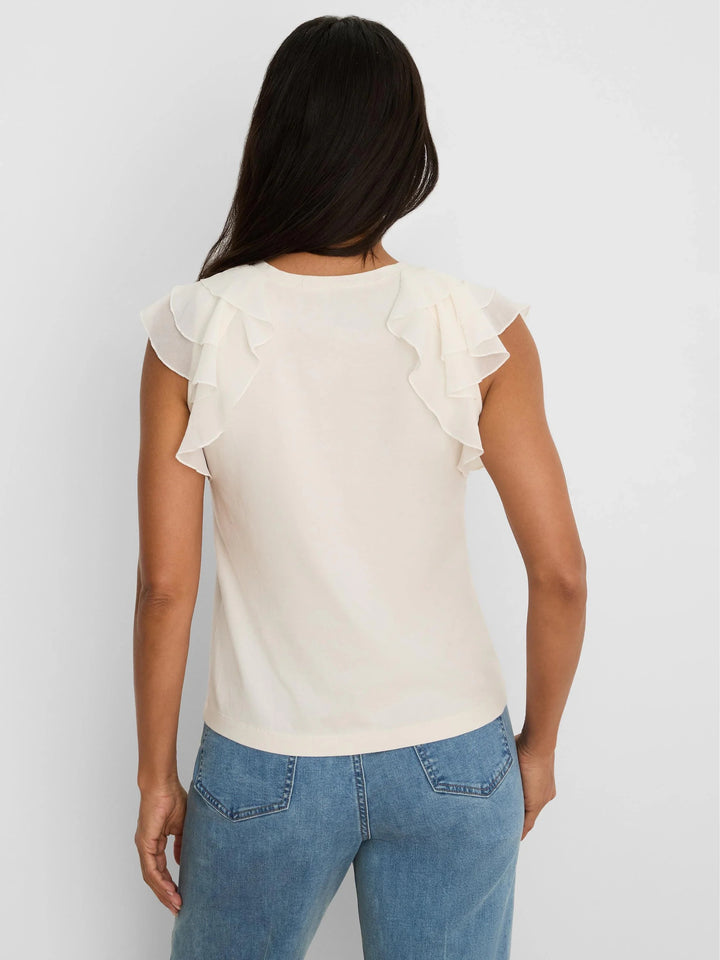 Light blue Nic & Zoe chiffon drift top with flowy fabric and relaxed fit, shown on a model with a casual, stylish look.